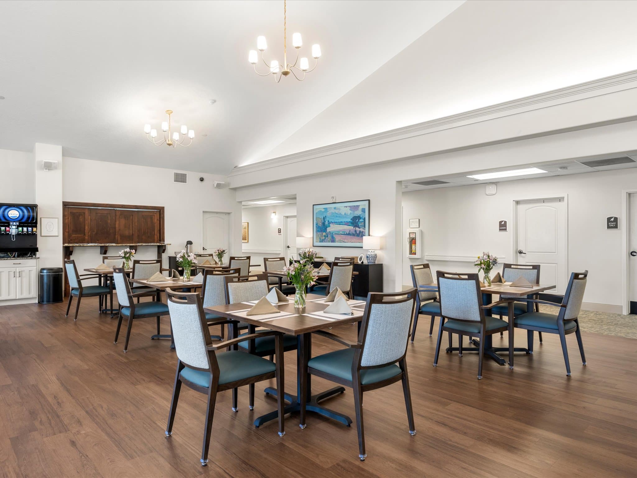 Assisted living dining room with a beverage station and lounge seating