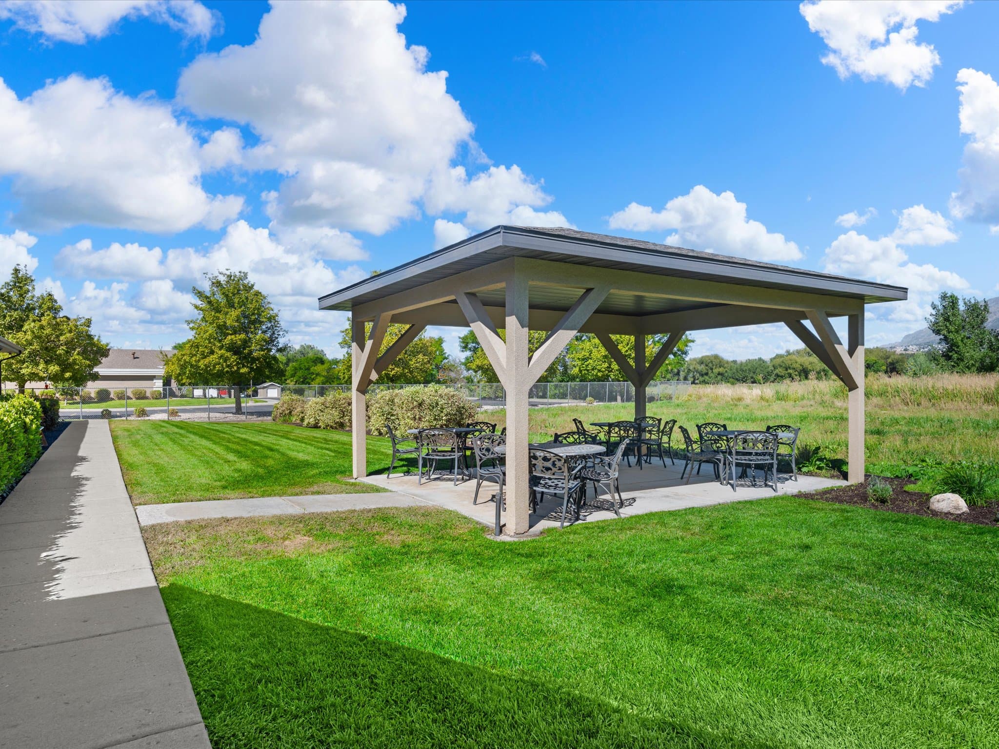 Covered pergola with outdoor seating on the lawn
