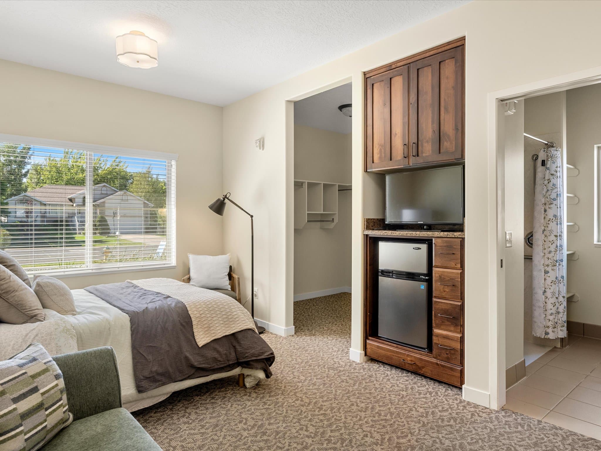 Built-in refrigerator and TV nook in an assisted living model apartment